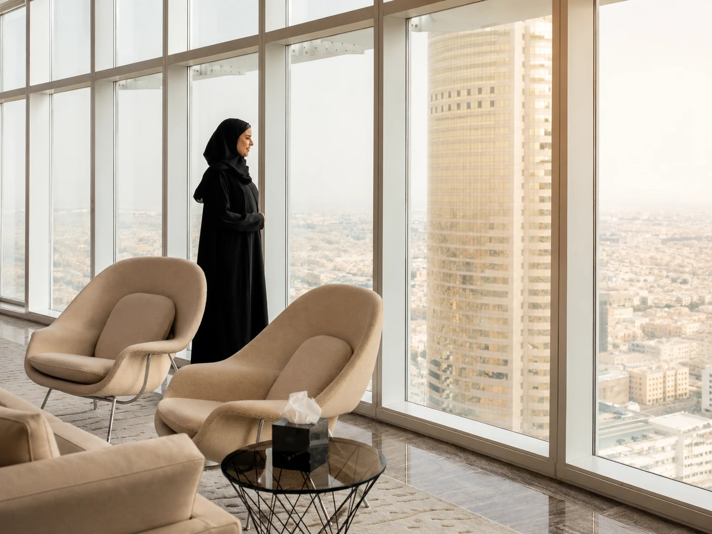 A Saudi professional overlooking Riyadh from a financial district tower