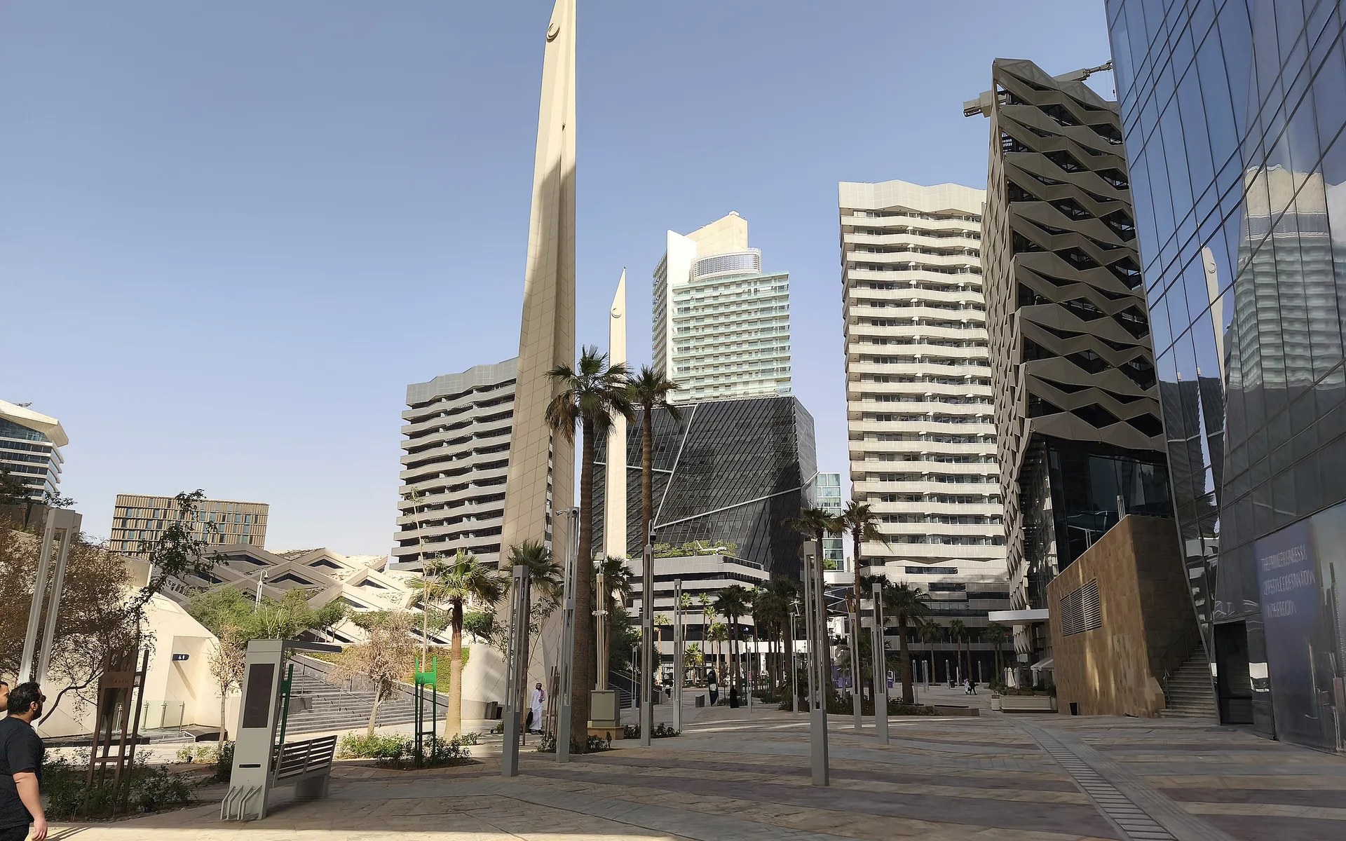 Boulevard lined with palms between the towers of the King Abdullah Financial District